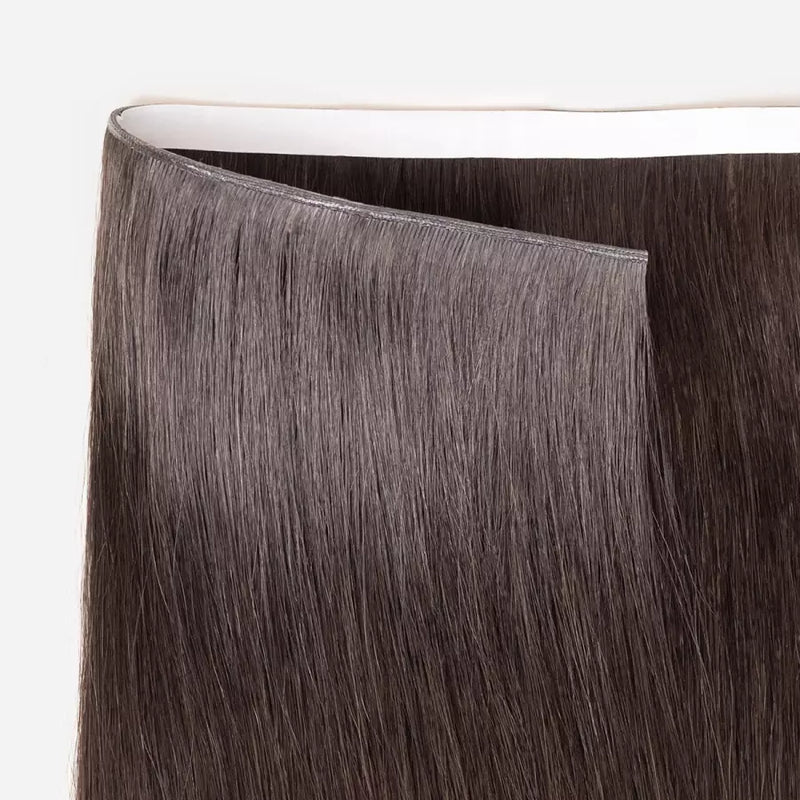 Load image into Gallery viewer, Close-up of brown tape in weft hair extensions on a white background