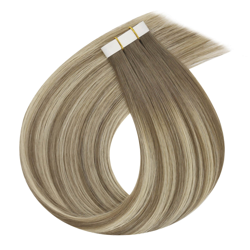 Load image into Gallery viewer, One bundle of straight invisible tape-in weft hair extensions featuring blonde highlights, secured with white bands and gold elastic ties, displayed on a white background.