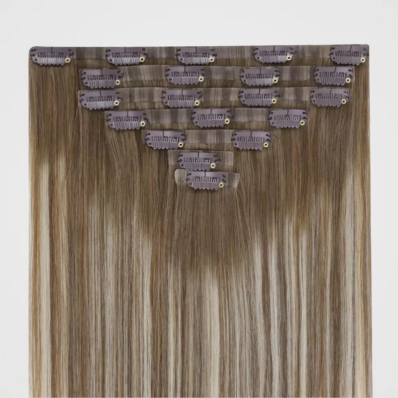 Load image into Gallery viewer, Set of invisible clip hair extensions with clips on a light gray background