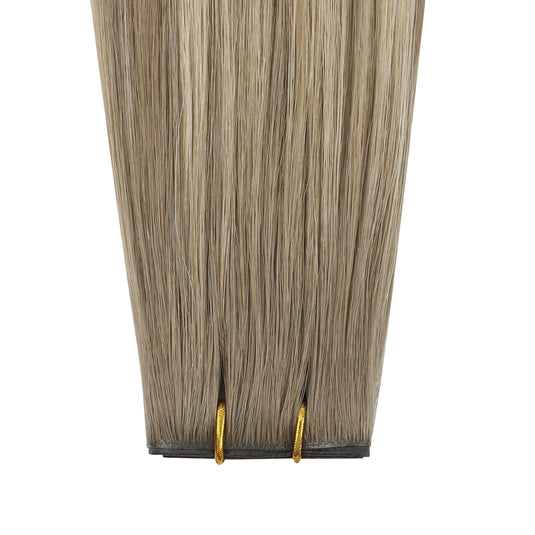 Invisible butterfly weft hair extensions with brown and blonde highlights on a white background