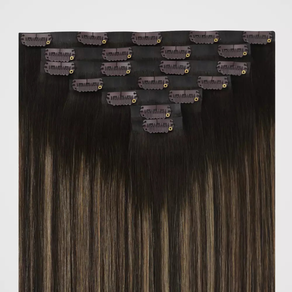 Set of balayage brown clip in hair extensions on a white background