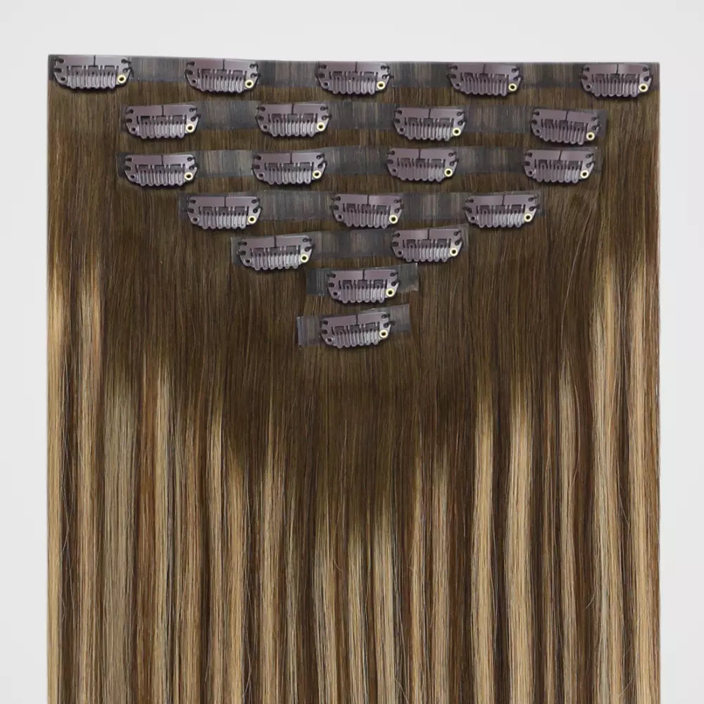 Set of balayage brown hair extensions on a white background
