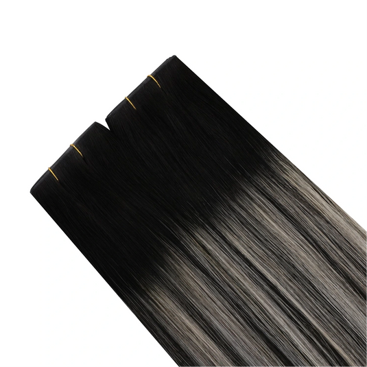 Black to gray ombre hair extensions on a white background