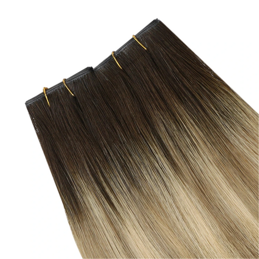 Two hair extensions with a gradient from blonde to brown on a white background