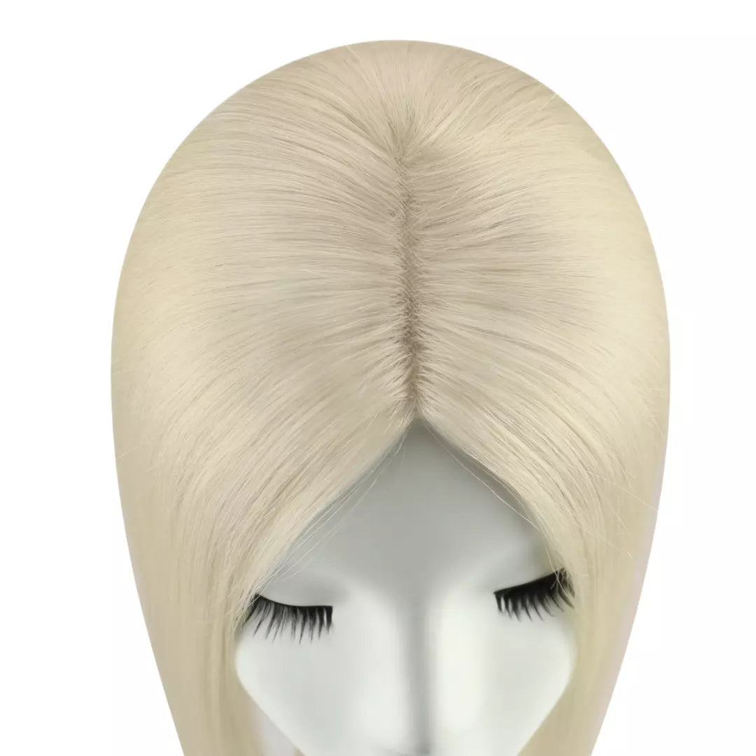 Blonde hair topper on a mannequin head against a white background