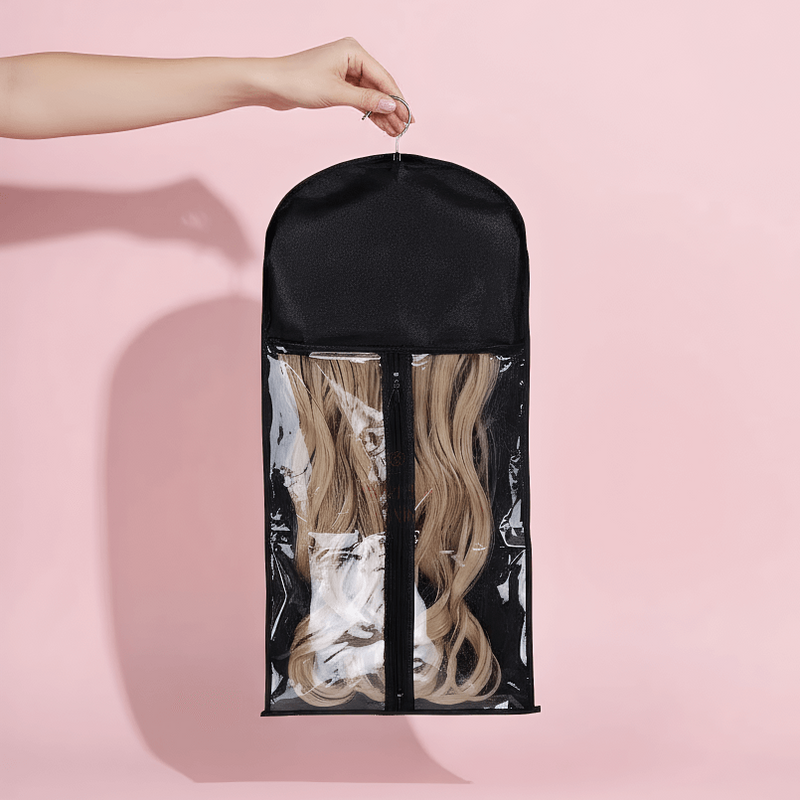 Load image into Gallery viewer, Black hair extension carrier with clear front on a pink background
