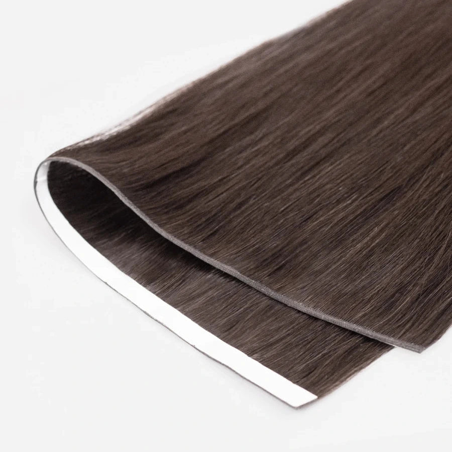Brown tape in weft hair extensions on a white background