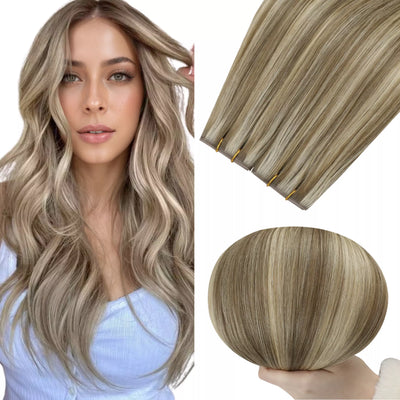 Woman with long wavy hair next to hair extensions on a white background