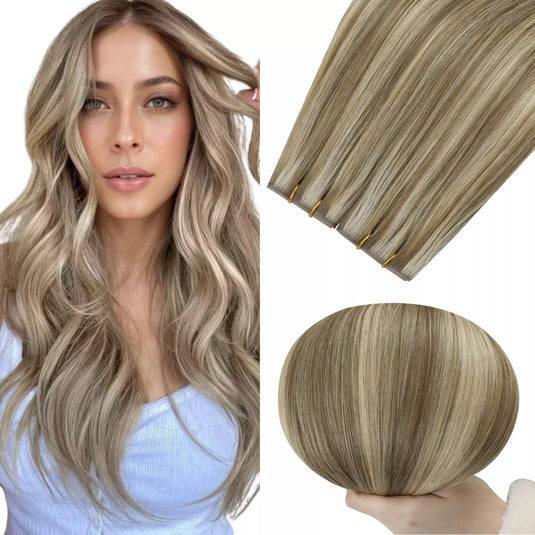 Woman with long wavy hair next to hair extensions on a white background