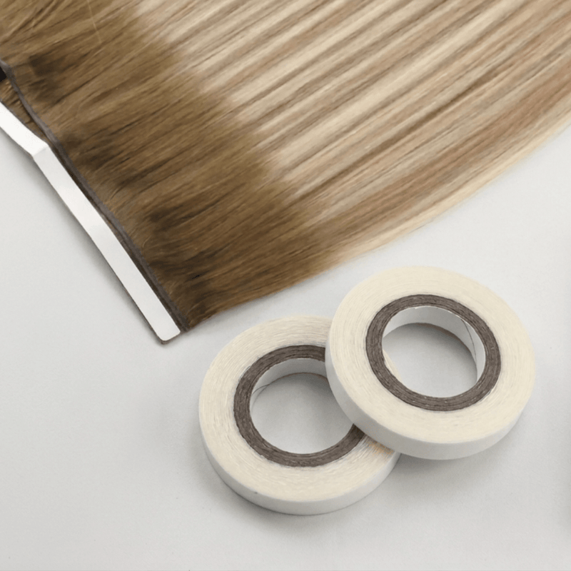Load image into Gallery viewer, Hair extensions with tape on a light gray background
