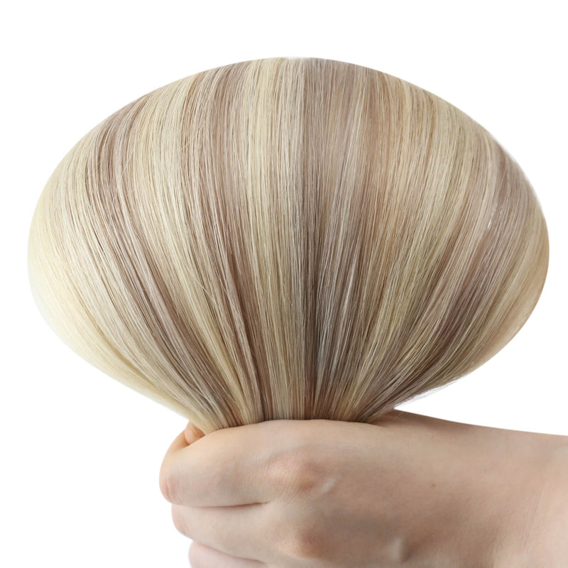 Load image into Gallery viewer, Hand holding a seamless tape in hair extension with highlight blonde color on a white background

