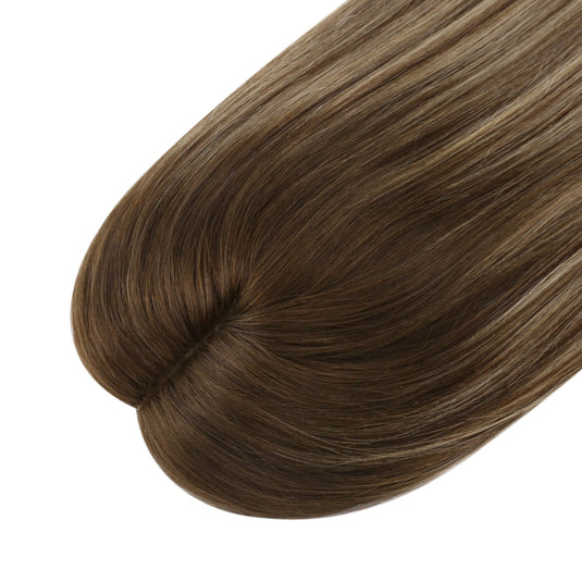 A close-up of a hair topper with straight, glossy brown hair featuring subtle lighter brown highlights, shown against a plain white background.