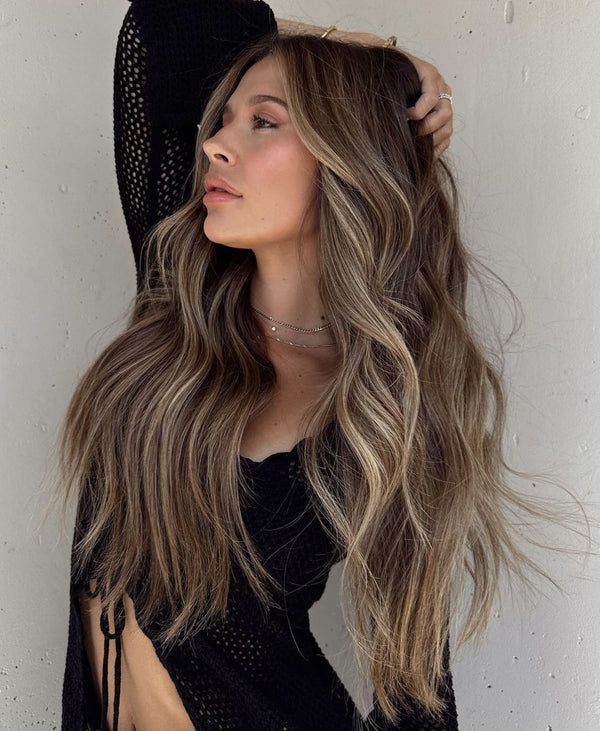 Woman with long, wavy hair against a light background