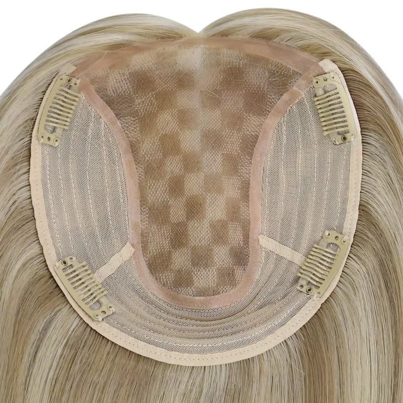 Load image into Gallery viewer, A close-up of a straight hairpiece section, showing the beige adhesive base and dark mesh with clip-in springs, on a plain white background.
