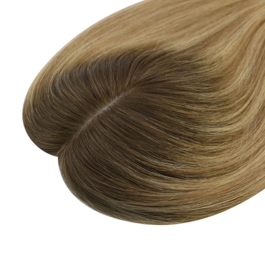 A close-up of a hair topper section with straight, smooth strands in balayage brown color, on a plain white background.