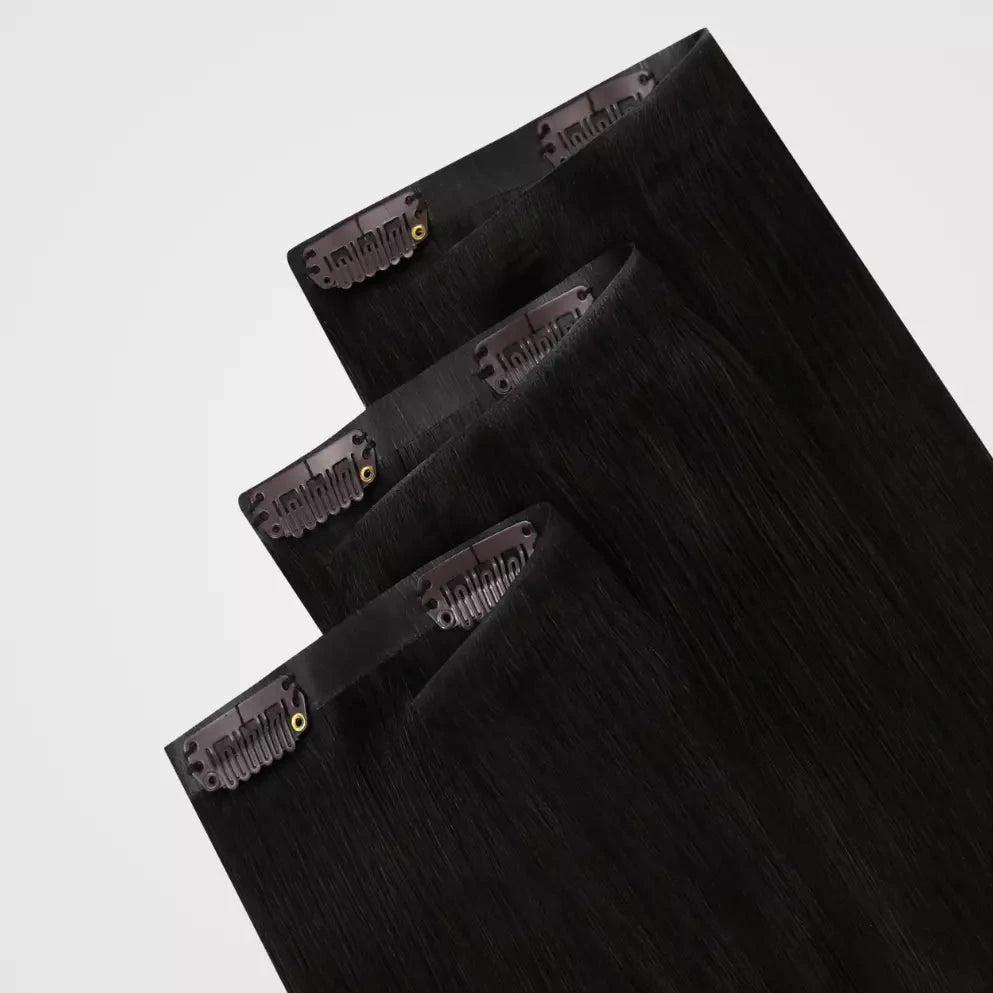 Brown remy clip in hair extensions on a white background