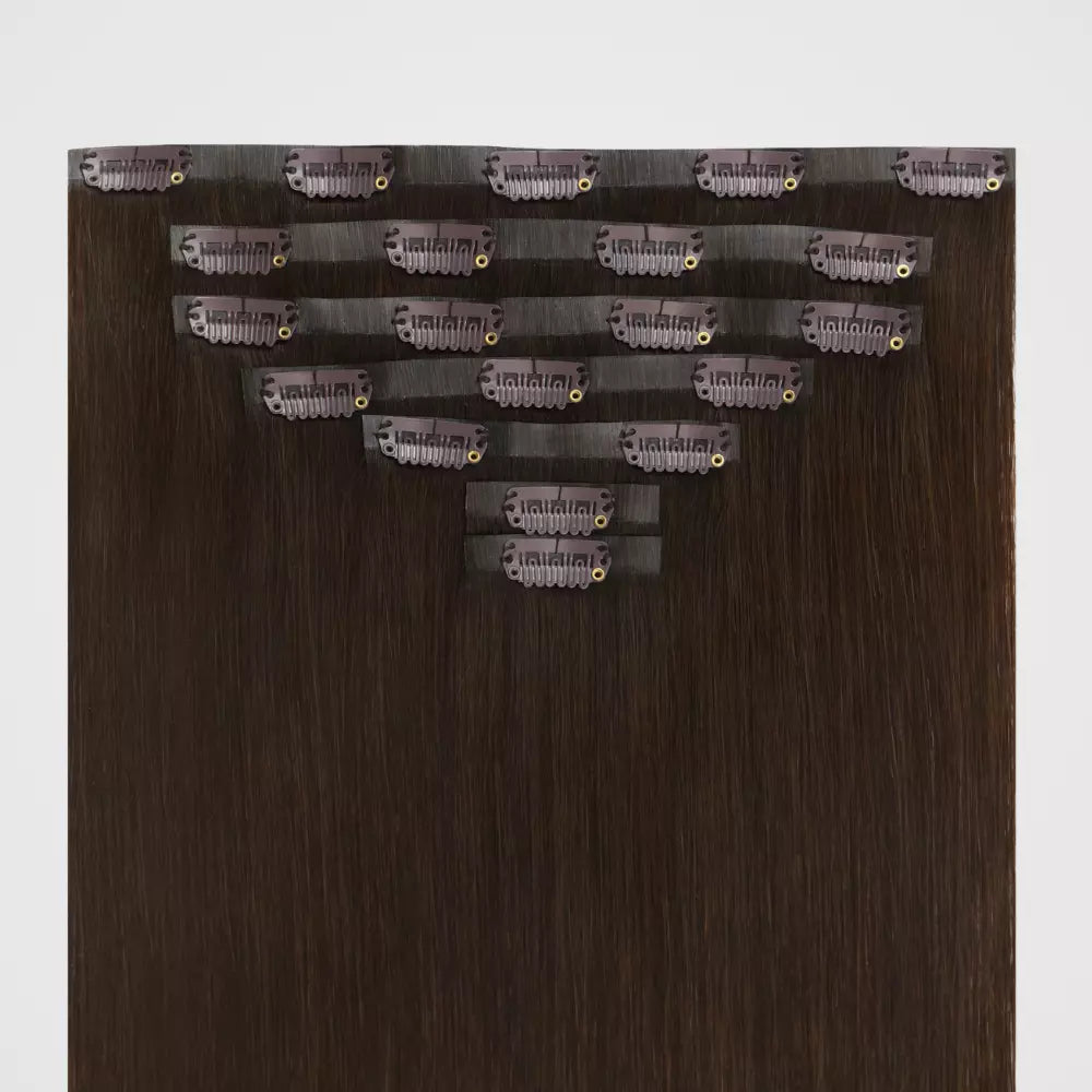 Brown remy clip in hair extensions on a white background