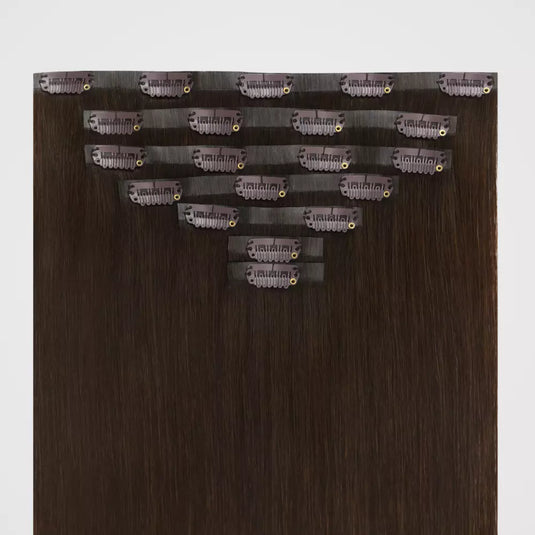 Brown remy clip in hair extensions on a white background