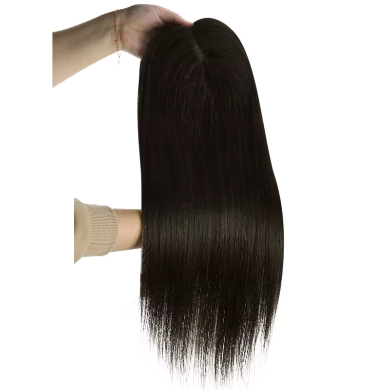 Load image into Gallery viewer, A long hairtopper with a natural black color, held up by a hand against a plain white background.
