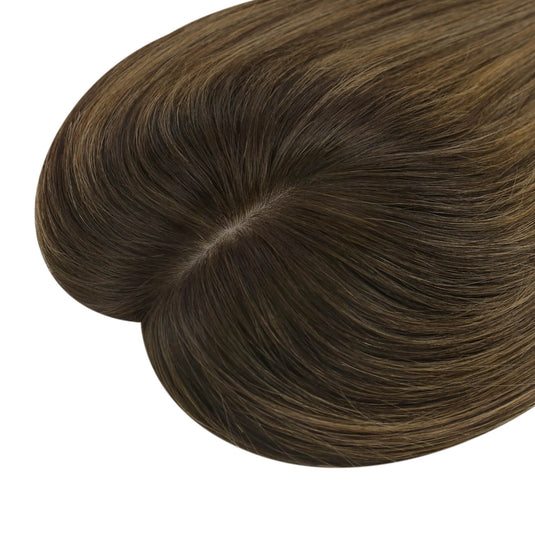 A close-up of a hair topper section with straight, smooth strands in balayage brown color, on a plain white background.