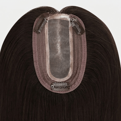 Hairpiece with a visible brand label on a white background