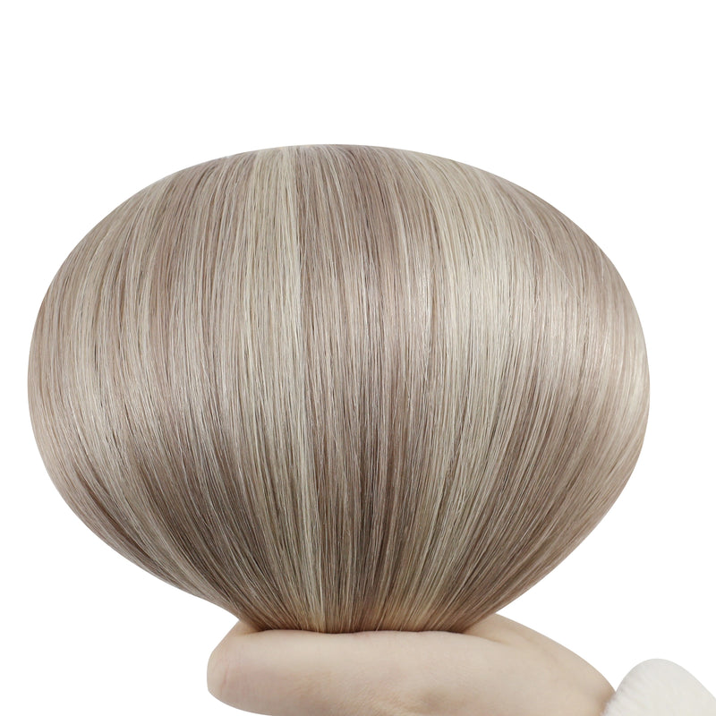 Load image into Gallery viewer, Hand holding a butterfly weft with highlight blonde color on a white background
