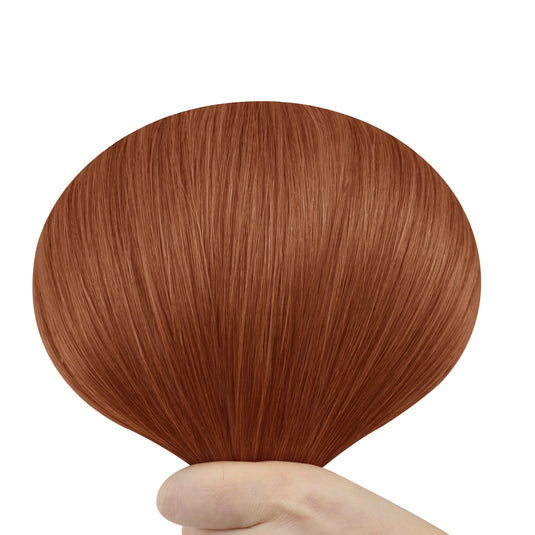 Hand holding a butterfly weft with copper red color on a white background