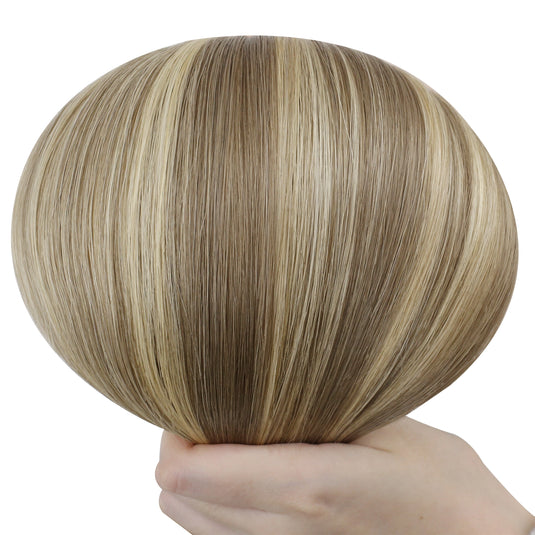 Hand holding a butterfly weft with brown and blonde color on a white background