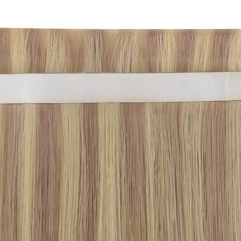 Load image into Gallery viewer, Close-up view of pink blonde highlight tape-in weft hair extensions.
