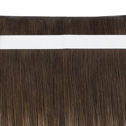 A close-up of straight dark brown hair extensions with a white adhesive band at the top, shown against a white background.