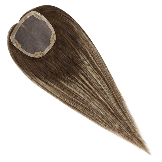 A straight hair piece with a heart-shaped attachment cap, featuring light brown to blonde balayage highlights, shown on a solid white background.