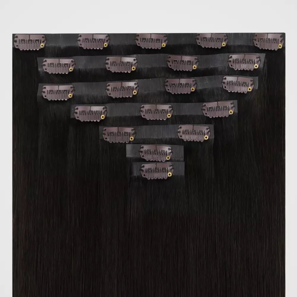 Brown remy clip in hair extensions on a white background