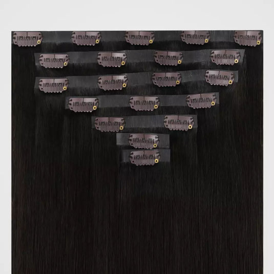 Brown remy clip in hair extensions on a white background
