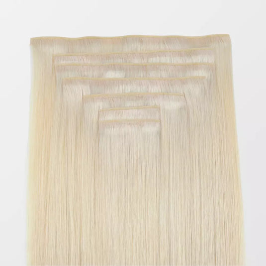 Set of blonde hair extensions on a white background