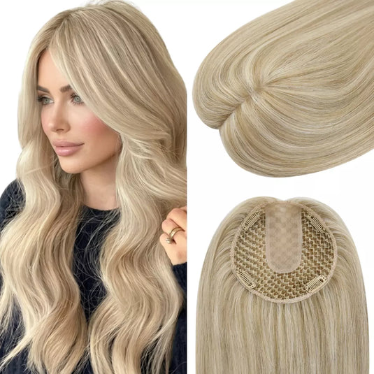 Woman with long wavy hair wearing an blonde topper on a white background