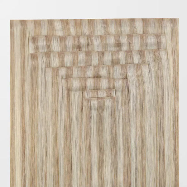 Set of blonde clip in hair extensions on a white background
