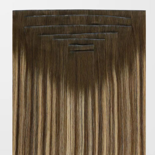 Set of balayage brown hair extensions on a white background