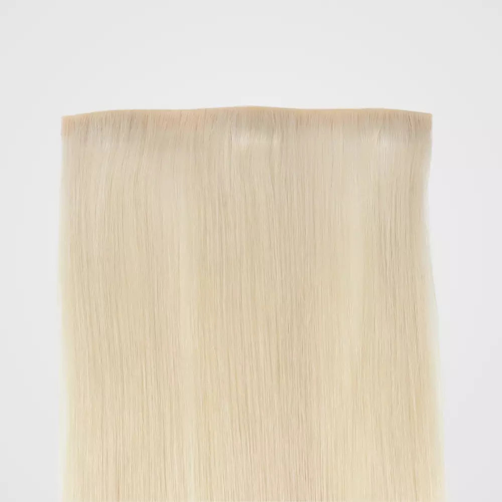 Blonde clip in hair extensions on a white background