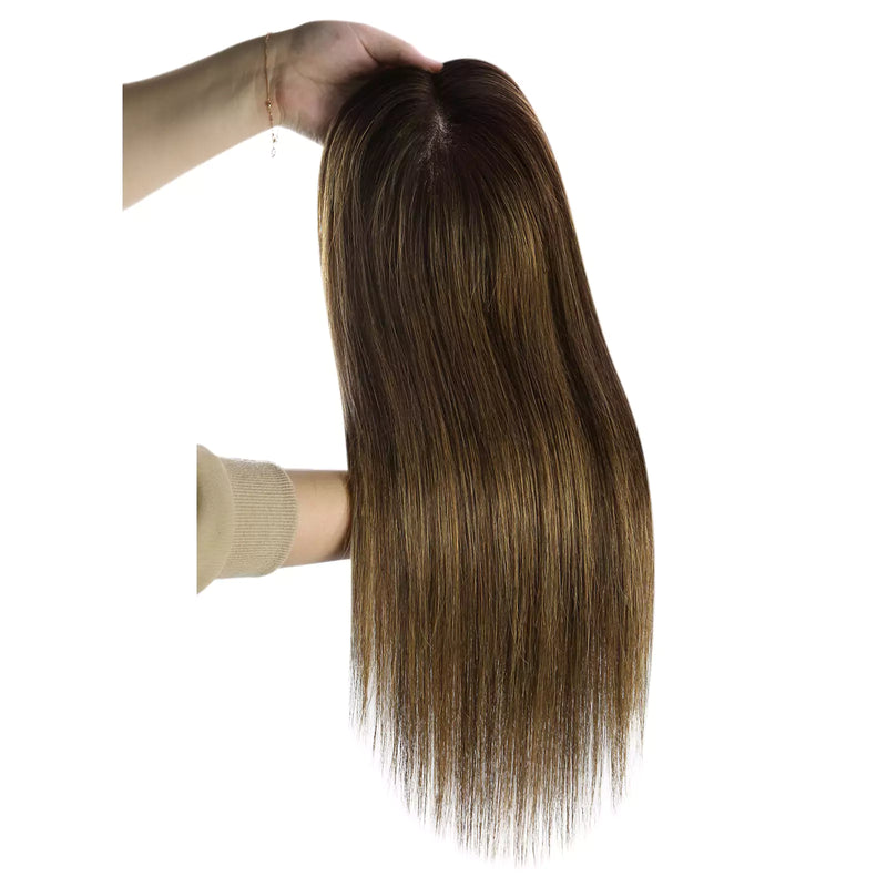 Load image into Gallery viewer, A long hairtopper with a dark brown and blonde ombré color, held up by a hand against a plain white background.
