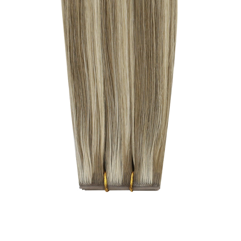 Load image into Gallery viewer, Invisible butterfly weft hair extensions with brown and blonde highlights on a white background
