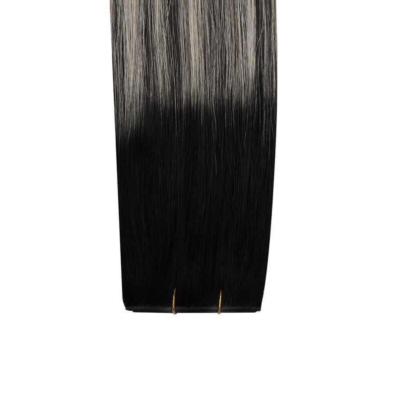 Load image into Gallery viewer, Black butterfly weft hair extension with a gradient to gray on a white background

