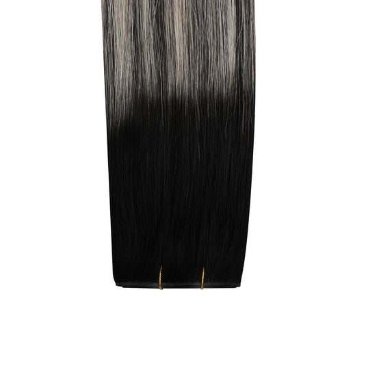 Black butterfly weft hair extension with a gradient to gray on a white background