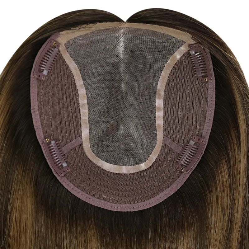 Load image into Gallery viewer, A close-up of a straight hairpiece section, showing the brown adhesive base and dark mesh with clip-in springs, on a plain white background.
