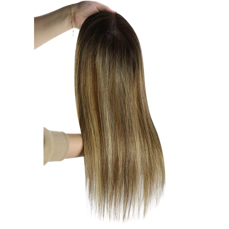 Load image into Gallery viewer, A long hairtopper with a warm golden-brown and light blonde ombré color, held up by a hand against a plain white background.
