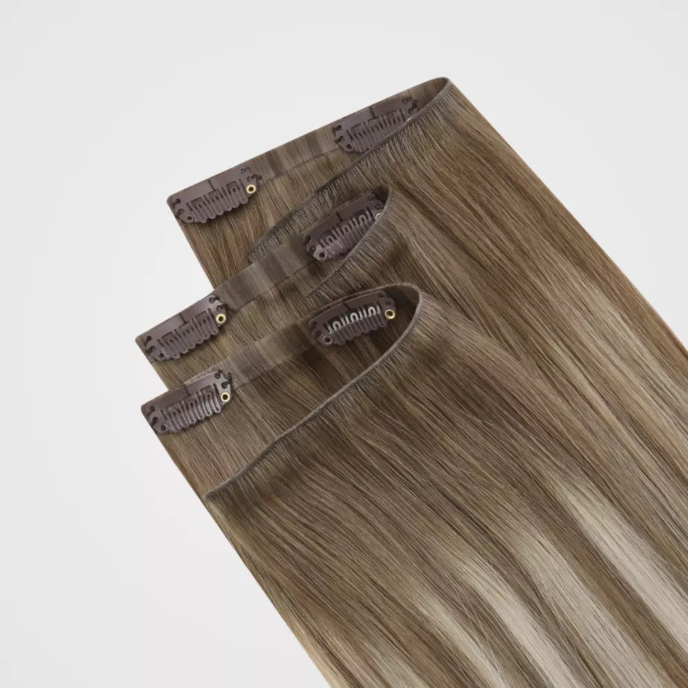 Set of clip hair extensions on a light gray background