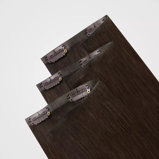 Set of clip hair extensions on a light gray background