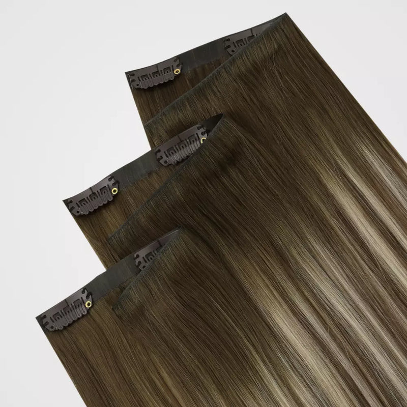 Load image into Gallery viewer, Three rectangular hair extension pieces with dark metal clip-in edges, shown overlapping on a light gray background. 
