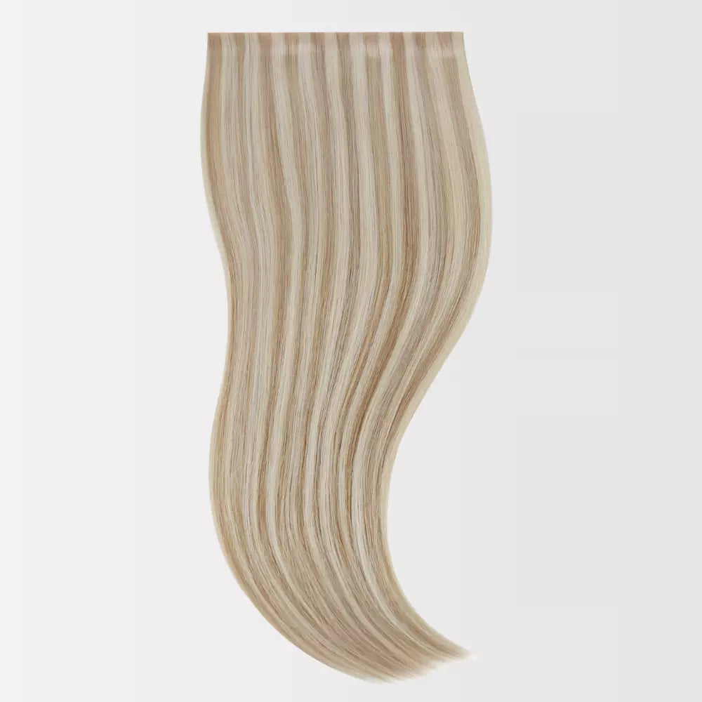 Blonde hair extension on a light gray background