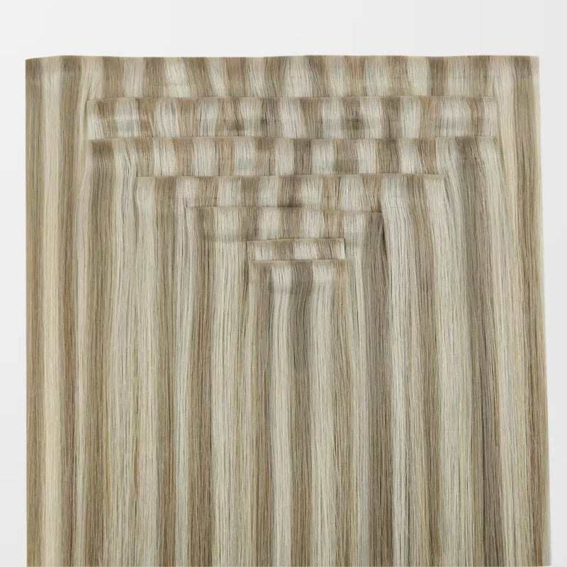 Load image into Gallery viewer, A close-up of blonde highlights clip in hair extensions on a white background
