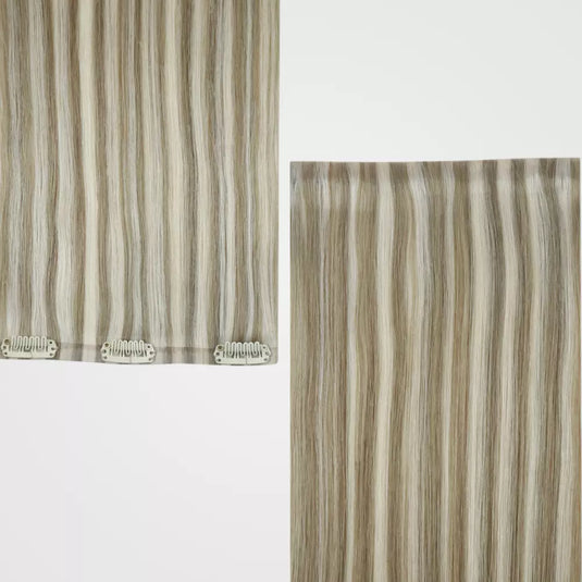 A close-up of blonde highlights clip in hair extensions on a white background